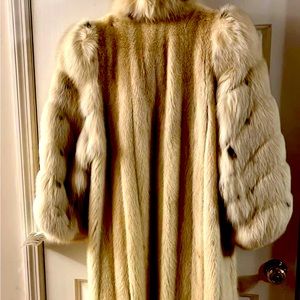 A full length mink coat with fox sleeves and collar